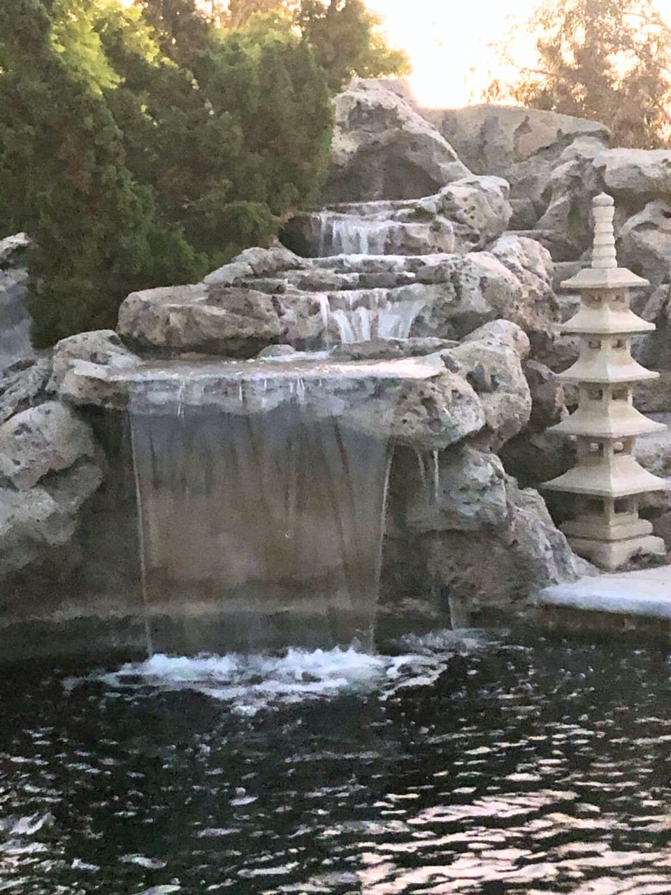 Faux-rock cascade with pagoda lantern on a lit pond