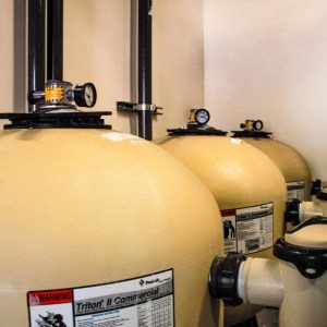 Bank of Pentair commercial filter tanks with pressure gauges