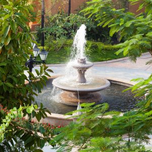 Tiered fountain spraying in a planted courtyard