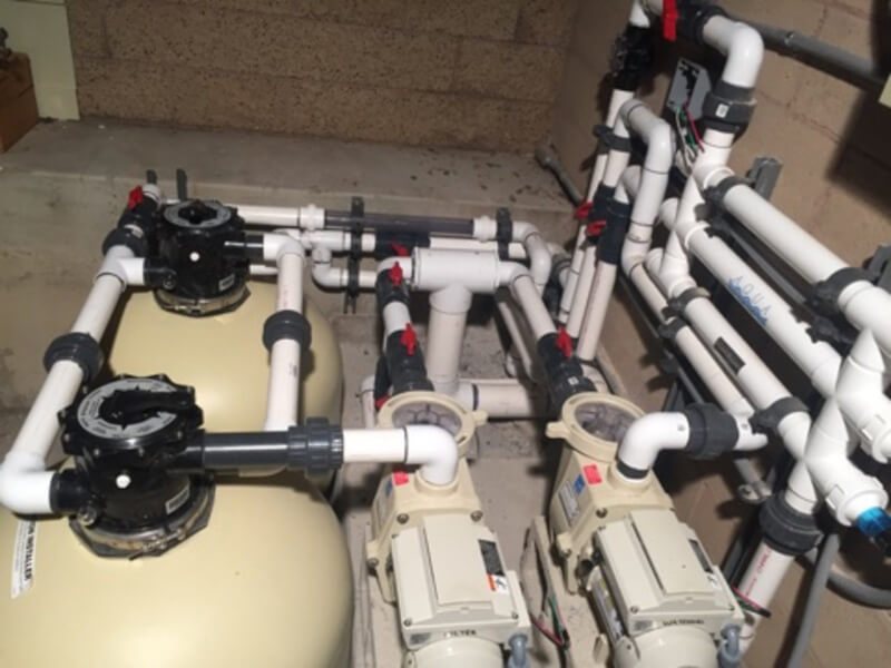 Commercial equipment pad: twin sand filters, two pumps and valved manifold