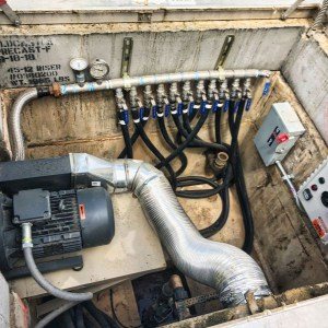 Below-grade equipment vault with pump, air manifold and control panel