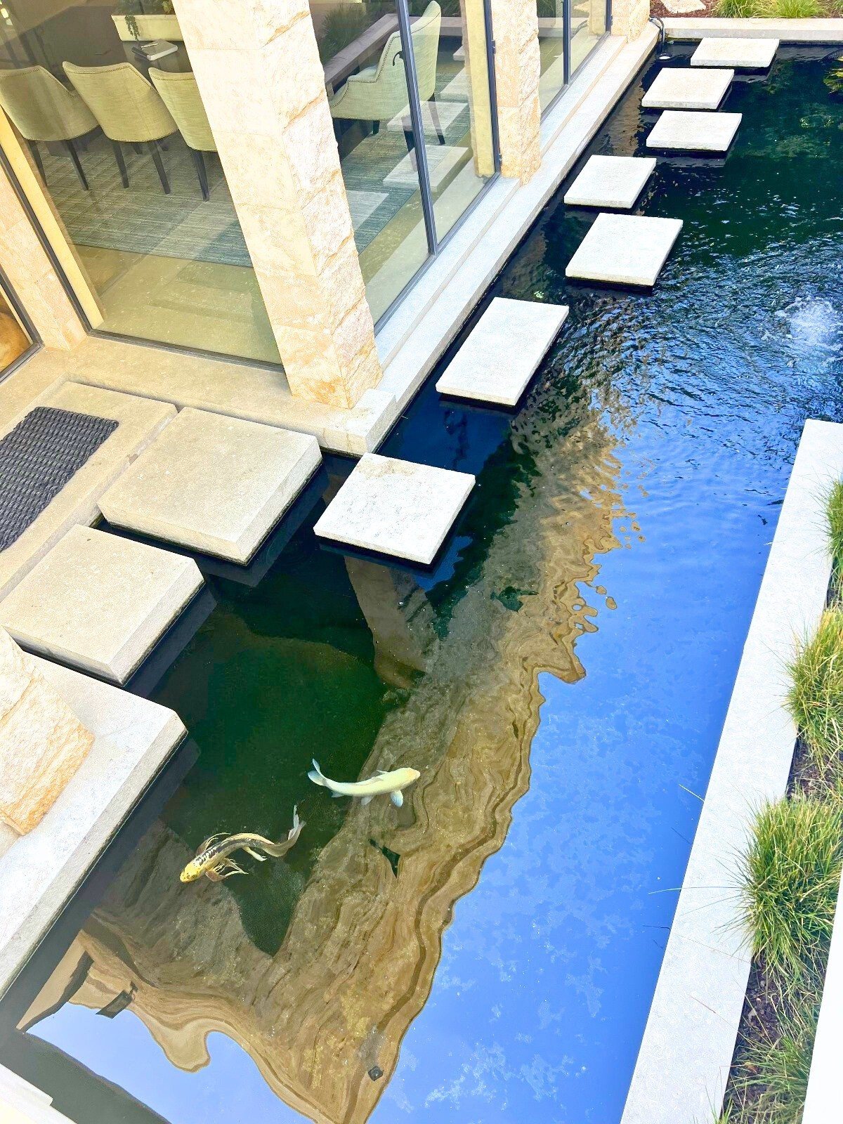 Modern koi channel with floating concrete pavers