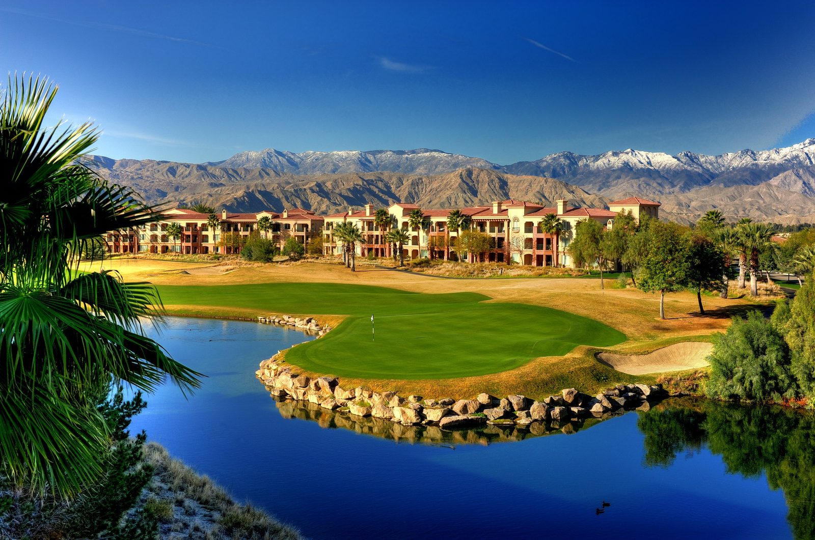 Golf resort lake and island green below the mountains, Palm Desert