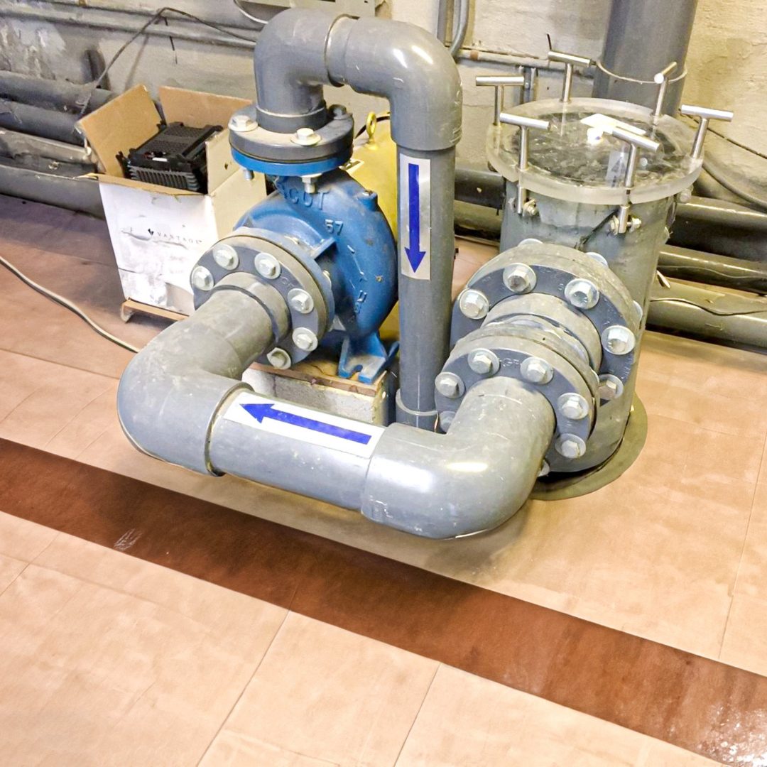 Blue Scot pump with valved manifold and strainer on an equipment pad