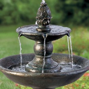 Small tiered cast-stone fountain in a garden